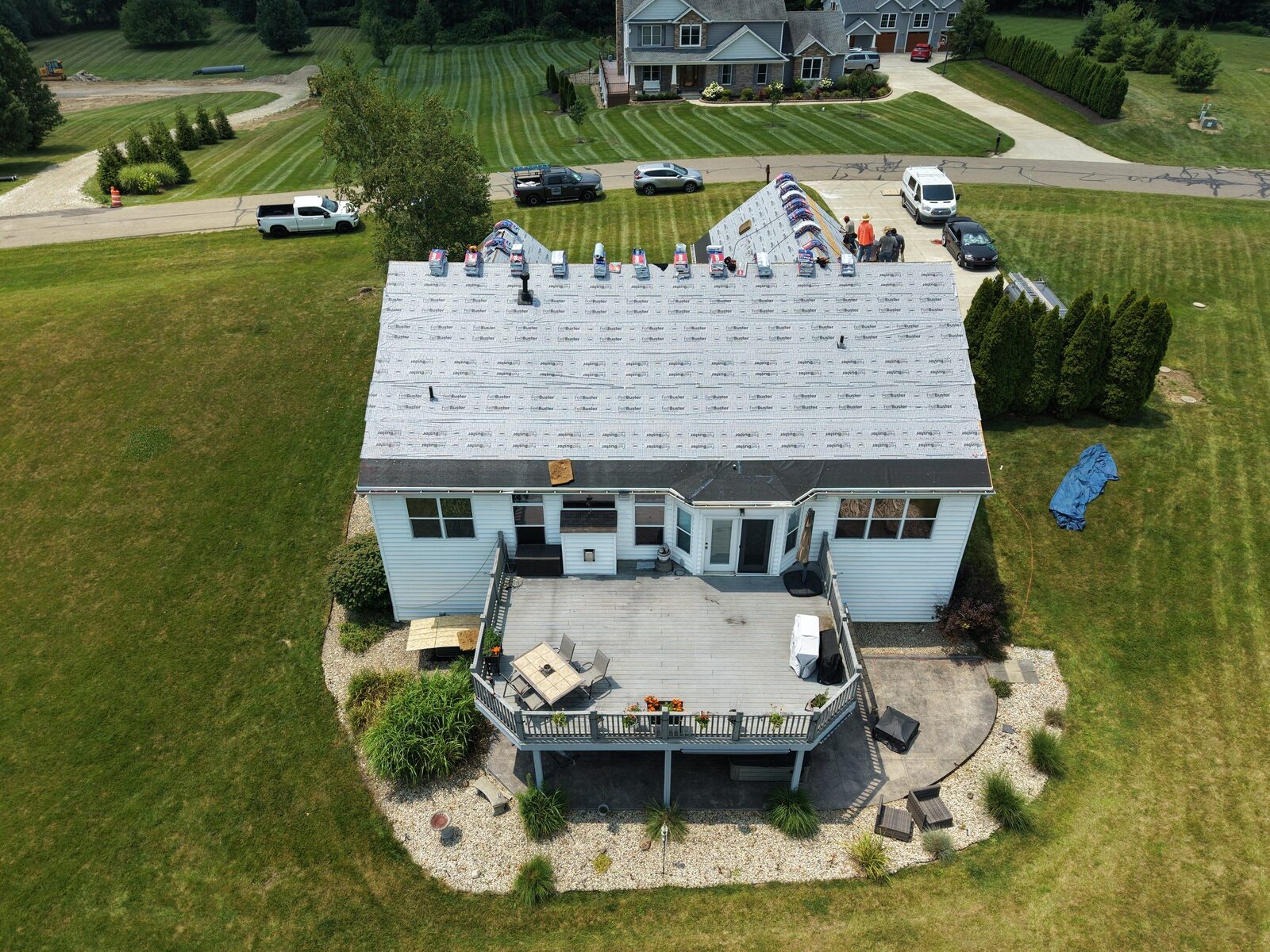 Underlayment down and new shingles staged across the whole roof