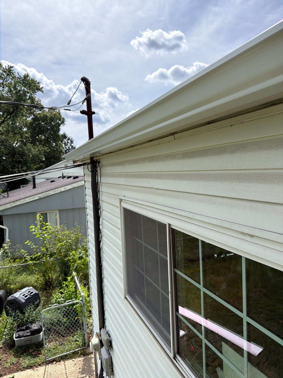 Clean lines where the new gutter meets the gable end